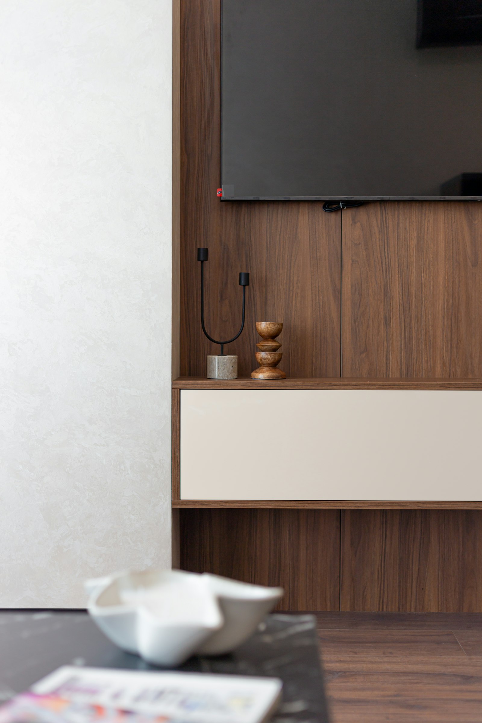 Television mounted on a wood wall panel